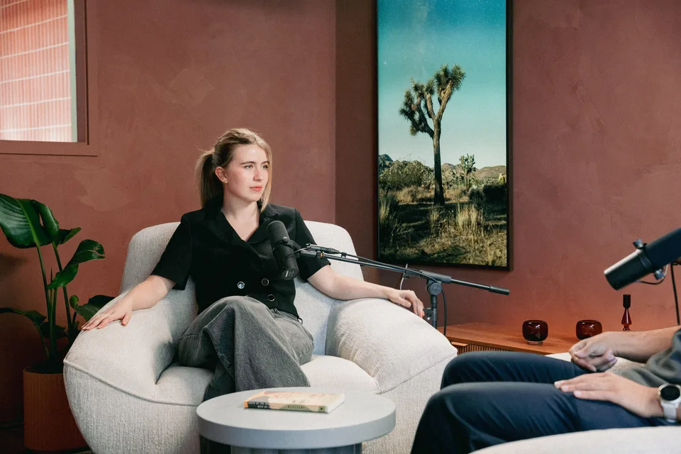 A host mid-conversation with a guest in The Oasis Room